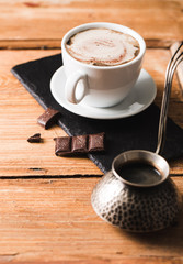 Black coffee with milk flatlay view on wooden background