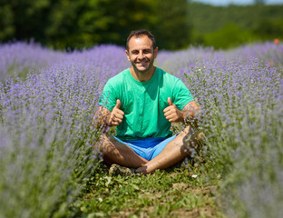 Naklejka na ściany i meble Happy farmer in his lavender field