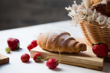 Breakfast croissants with fresh raspberries morning concept