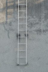The ladder is attached to the side of the building. © lapis2380