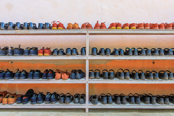 The student's shoes on the wooden shelf in Thai rural primary school.