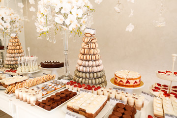 Delicious candy bar with macarons, cupcakes, cake pop and other sweets