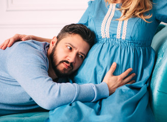 Husband hugs the belly of the pregnant wife.Family and pregnancy concept.