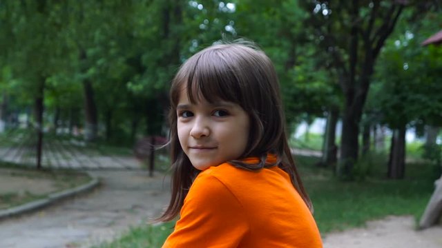 Cheerful Smiling Girl In A Garden. Close up portrait of litle girl.