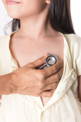 Pediatrician examining little girl's heart