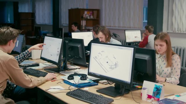 Group of Young Architects is Working at their Computers on Projects in the Office with OpenSpace Room
