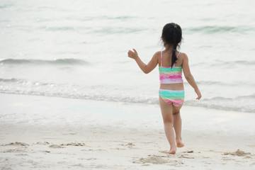 Fototapeta na wymiar Adorable happy smiling little girl on beach vacation