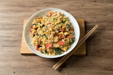 Fried rice with egg and wood grain background