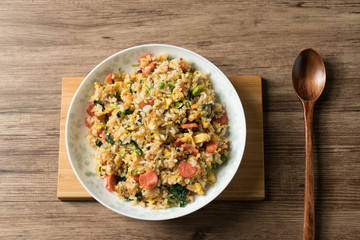 Fried rice with egg and wood grain background
