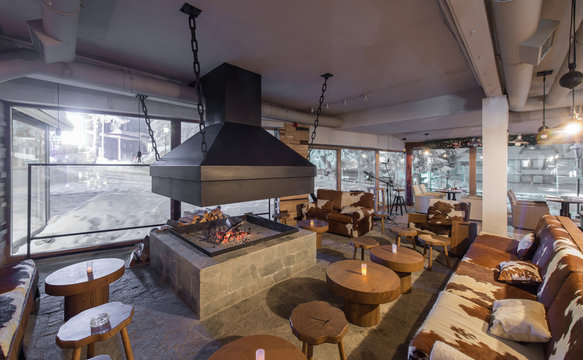 Retro designed restaurant interior with big fireplace