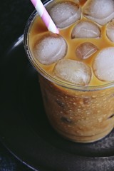 Fototapeta na wymiar Iced latte to go on the dark backgroind. Iced coffee isolated 