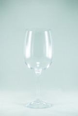 Closeup of a transparent empty wine glass. Isolated on the white background.