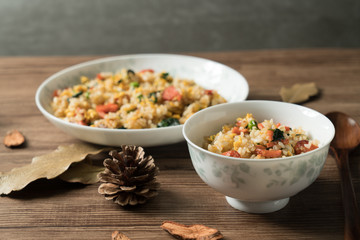 Fried rice with egg and wood grain background