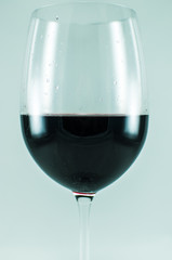Closeup of a full wine glass. Isolated on the white background.