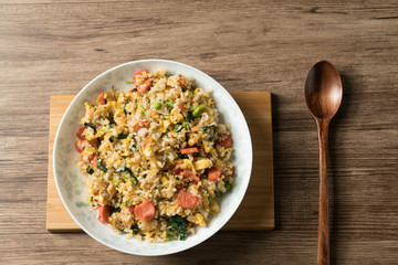 Fried rice with egg and wood grain background