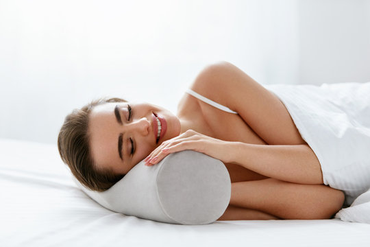 Neckroll Pillow. Woman Resting On Bed