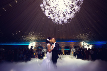 Happy bride and groom and their first dance, wedding in the elegant restaurant