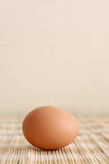 an egg on a brown straw placemat