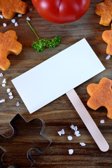 Puzzle shaped salty cookies with paprika and tomato paste and a white card for text in the middle