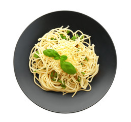 Plate of delicious pasta with cheese and basil on white background