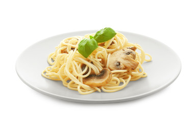 Plate of delicious pasta with mushrooms on white background