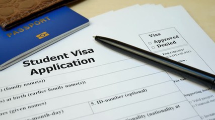 Student Visa application form with passport and pen. Document with passport, apply and permission for foreigner country