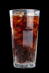 fizzy drink with ice in glass on dark background