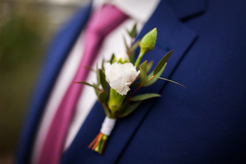 Stylish groom, wearing flower boutonniere,