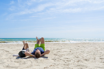 Fototapeta na wymiar Father and son relax on the beach