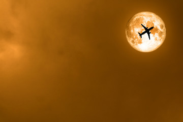 super full blood moon and silhouette airplane on moon