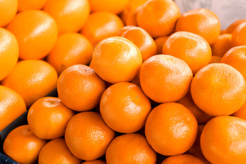 Many ripe tangerines, closeup. Fresh citrus fruit