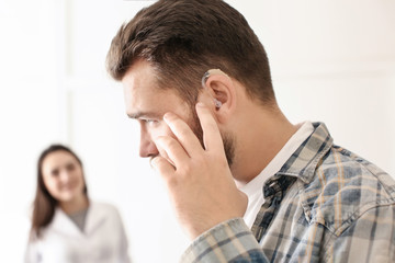 Man with hearing aid in otolaryngologist's office