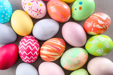 Colorful Easter eggs on table, top view