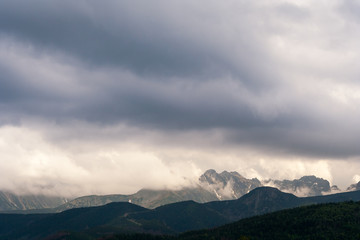 Dark gray and blue clouds above the mountains