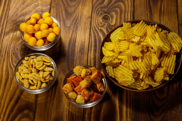 Mix of snacks for beer on wooden table