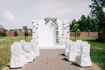 Wedding in a tent. Decoration of the hall. Green tablecloths, beautiful decor and dishes.