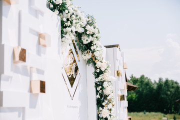 Wedding in a tent. Decoration of the hall. Green tablecloths, beautiful decor and dishes.