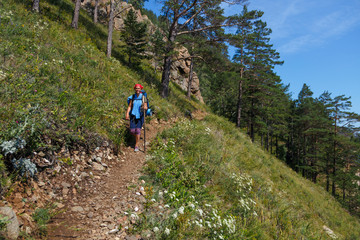 A woman hiking on a hill 