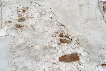 Old damaged wall of stones and concrete as background