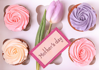 Box with tasty cupcakes and tulip. Mother's day celebration