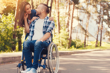 True love. Happy positive beautiful woman standing behind her boyfriend and looking at him while being supportive