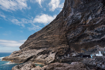 Hidden houses in the tourist attraction pirate cave of El Poris de Candelaria, in La Palma island, Canary islands, Spain.