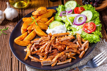 Rustic gyros plate it green salad and potato wedges