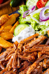 Rustic gyros plate it green salad and potato wedges