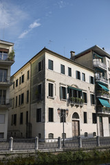 Fototapeta premium Treviso, Italy - May 29, 2018: Building facing River Sile