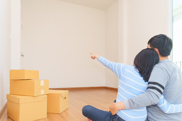 Couple in new home and think idea for have interior decoration.