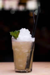 Cool lemonade in glass on wooden table in Summer