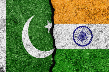 Flags of India and Pakistan  painted on cracked wall background/India - Pakistan relations concept