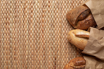 Various kind of bread put together on weave grass background with copy space.