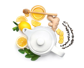 Flat lay composition with teapot, mint, lemon, honey and ginger on white background